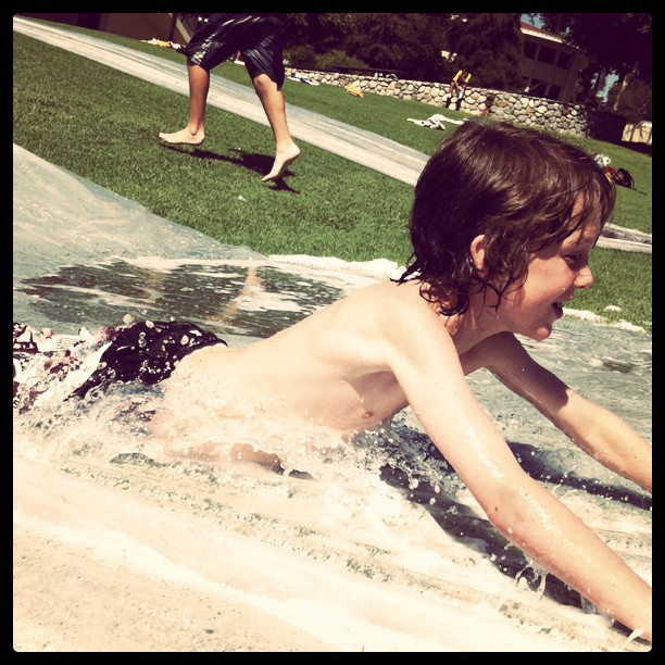 Leighton on the slippity slide. Check the floating guy in the background.  (Taken with instagram)